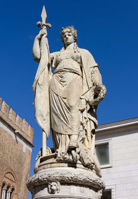 Low angle view of angel statue against clear blue sky