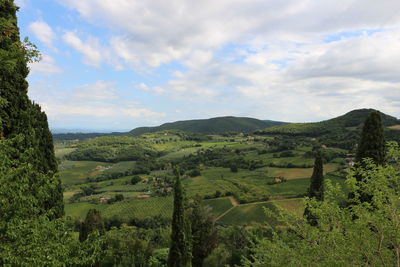 Countryside landscape against cloudy sky