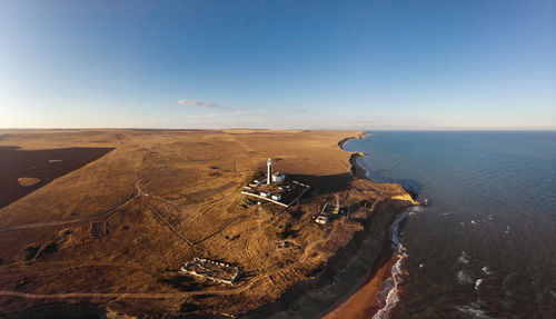 Aerial view of the lonely lighthouse standing on the edge of the cliff. at the edge of the sea 