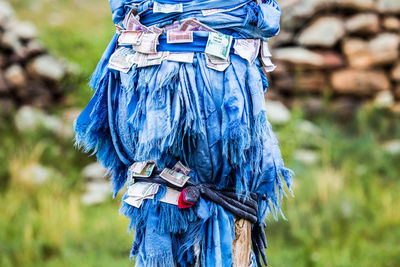 Close-up of paper currency tied on blue fabric outdoors