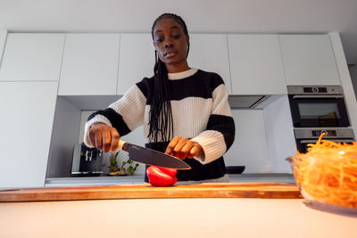 Portrait of young man using mobile phone at home