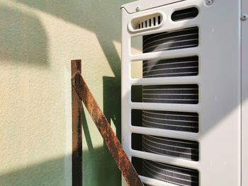 Close-up of metal railing against wall