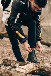 Low section of men standing on rock