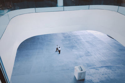 High angle view of people walking in swimming pool