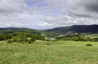 Scenic view of landscape against cloudy sky