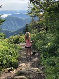 Rear view of woman standing on mountain