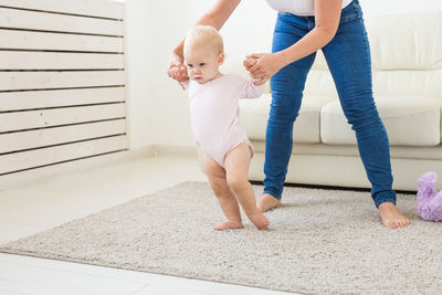 Full length of cute baby women on floor