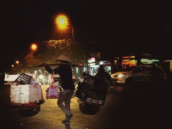 Blurred motion of woman in city at night