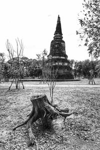 Exterior of temple on field against sky