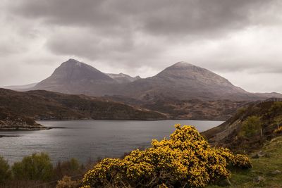 Scenic view of lake and mountains against sky