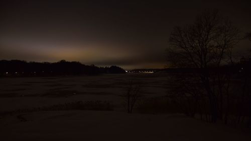 Scenic view of silhouette landscape against sky at night