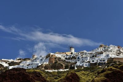 Low angle view of buildings against blue sky