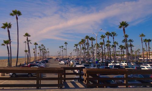 Chairs and tables at beach against sky