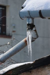 Close-up of icicle on sewage pipe