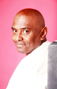 Close-up of senior man against white background