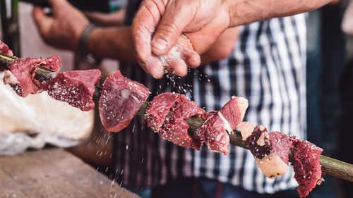 Midsection of man holding food