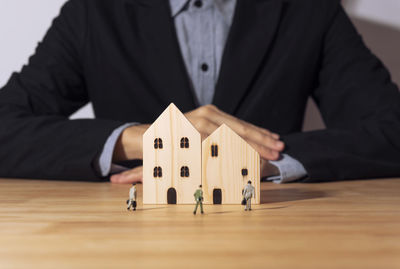 Close-up of man holding hands on table