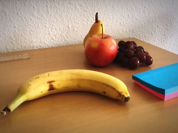 High angle view of apples on table against wall