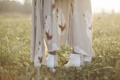 Low section of bare standing on field