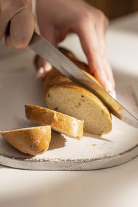 Woman cuts freshly baked bread