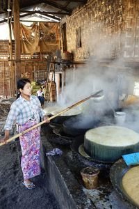 Woman holding ice cream in kitchen