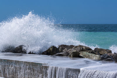 Sea waves splashing on rocks