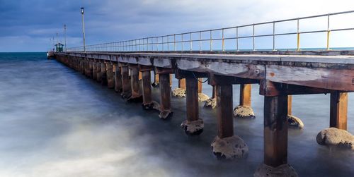 Pier over sea against sky