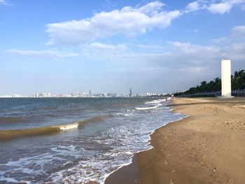 Scenic view of beach against sky in city