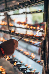 Cropped hand of woman holding illuminated light