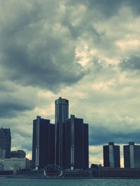 Skyscrapers against cloudy sky