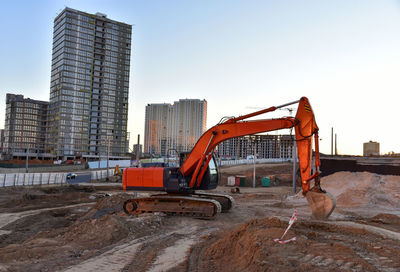 Excavator during excavation at construction site. backhoe on road work. heavy construction equipment