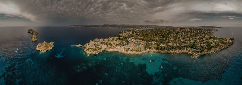 High angle view of rocks on sea shore against sky