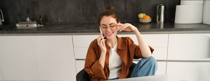 Side view of young woman standing in bathroom