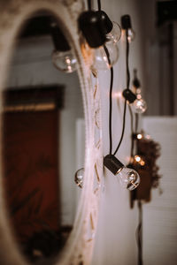 Close-up of light bulb hanging on wall