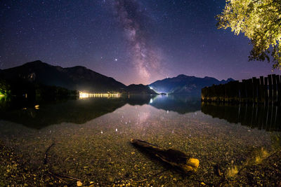 Scenic view of lake against sky at night