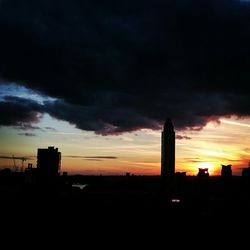 Silhouette of buildings against dramatic sky