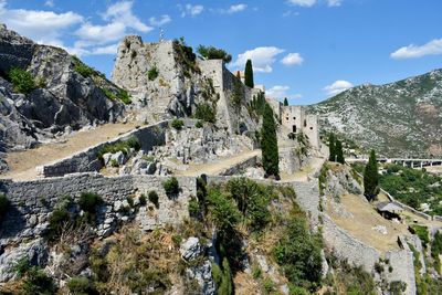 Panoramic view of trees and mountains against sky