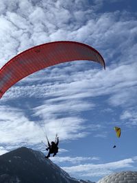 Low angle view of person paragliding against sky in interlaken 
