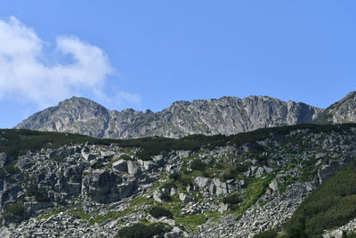 Scenic view of rocky mountains against blue sky