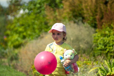 Portrait of cute girl holding balloons