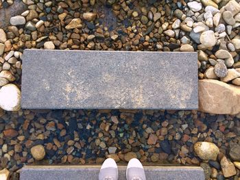 Low section of person standing on rock