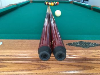 Close-up of cue with balls on pool table