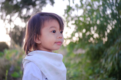 Portrait of cute girl standing outdoors