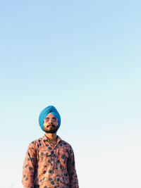 Portrait of man wearing turban against clear sky