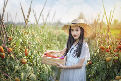 Woman wearing hat while standing on field