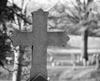 Close-up of cross against sky
