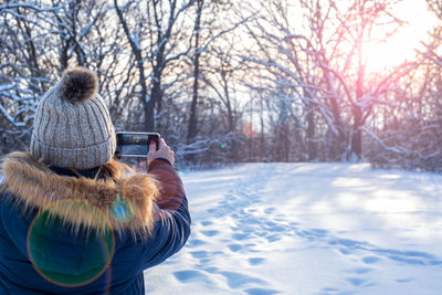 Rear view of woman on snow covered trees