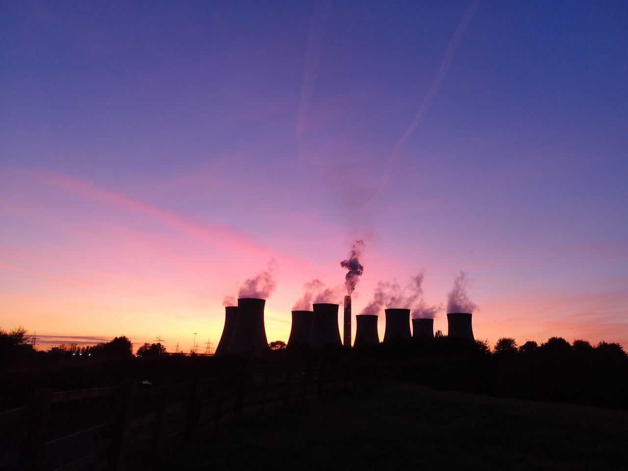 SILHOUETTE FACTORY AGAINST SKY DURING SUNSET