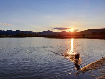 Scenic view of lake against sky during sunset