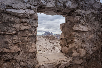 View of rock formation against cloudy sky